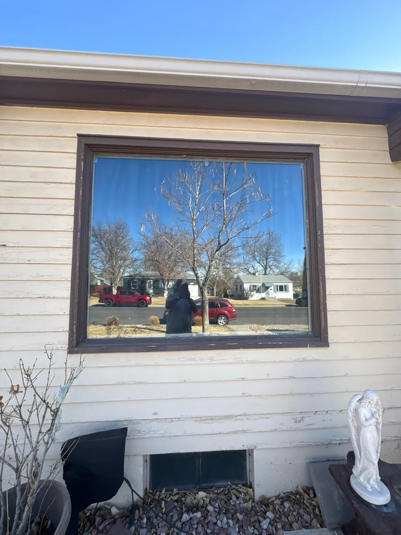 Original wood-framed picture window on the front of an Englewood home, before replacement